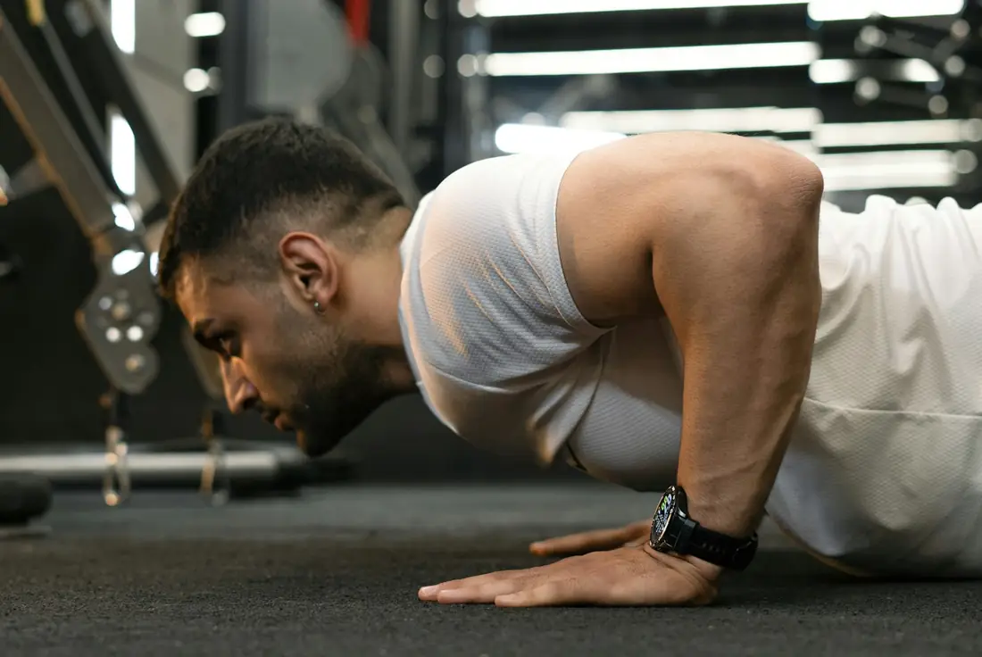 Man doing push-ups in a gym
